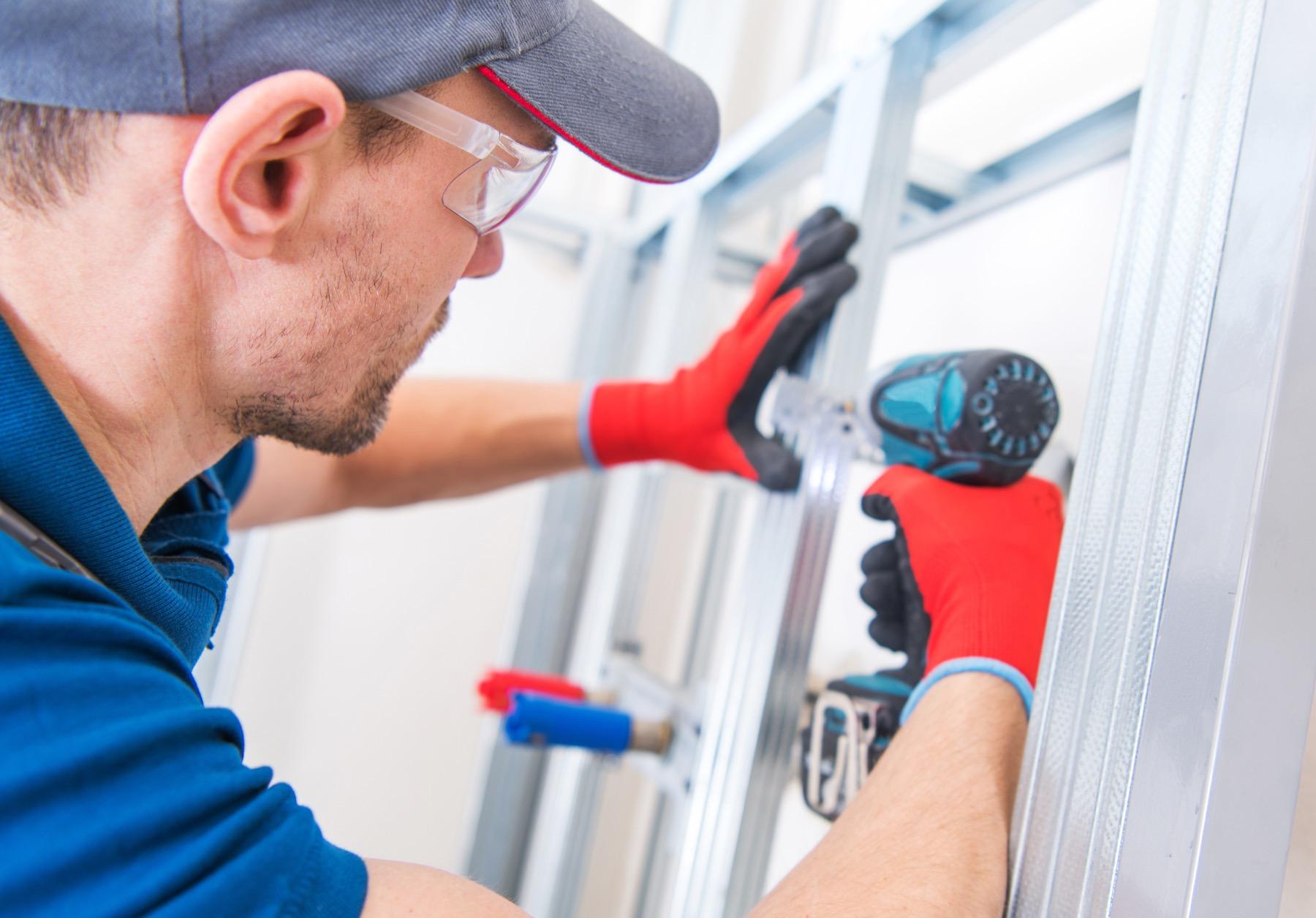 Bay Shore Garage Door technician repairing a garage door track